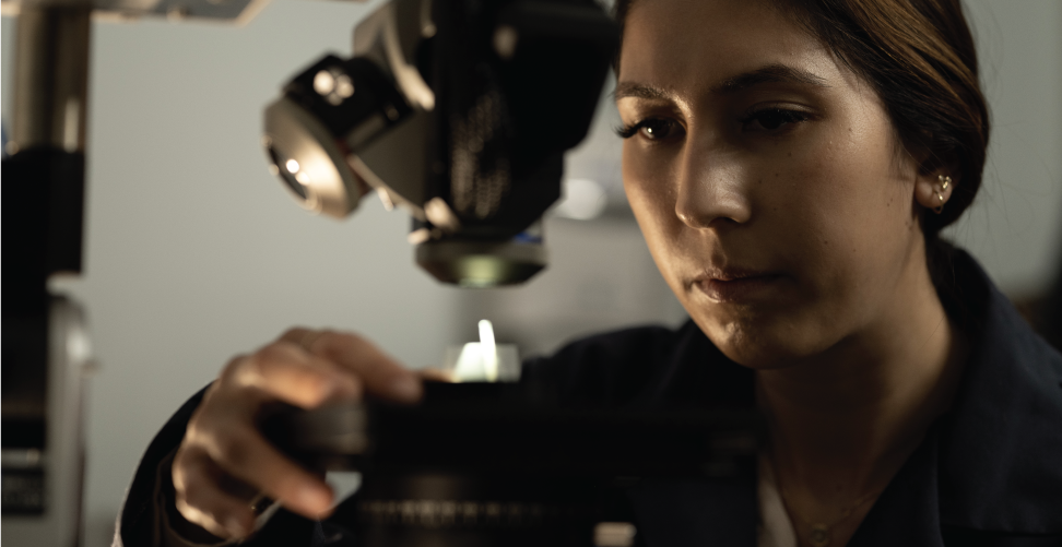 woman setting up microscope